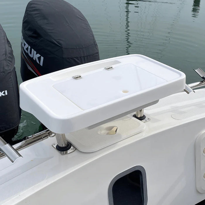 White, rectangular fishing bait station mounted on the back of a boat with two outboard motors. The station has a hinged lid and several smaller compartments.