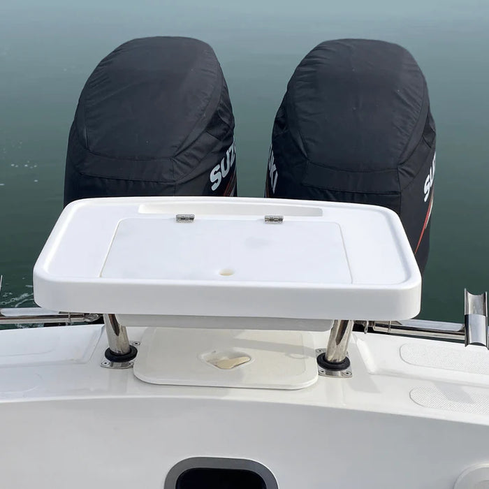 White, rectangular fishing bait station mounted on the back of a boat with two outboard motors covered in black engine covers. The station has a hinged lid and several smaller compartments.