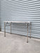 Stainless Steel folding table in front of garage roller door