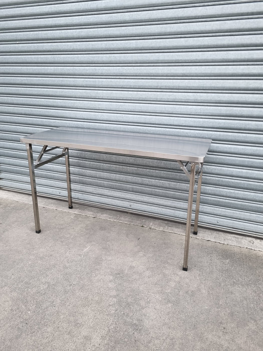 Stainless Steel Folding Table In front of roller door