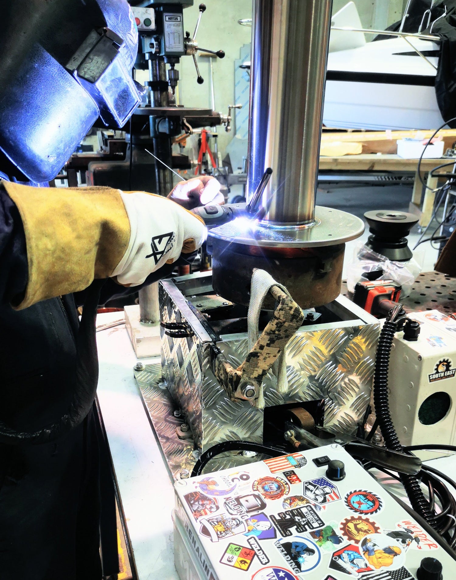 welder welding stainless steel on a rotary pipe welder