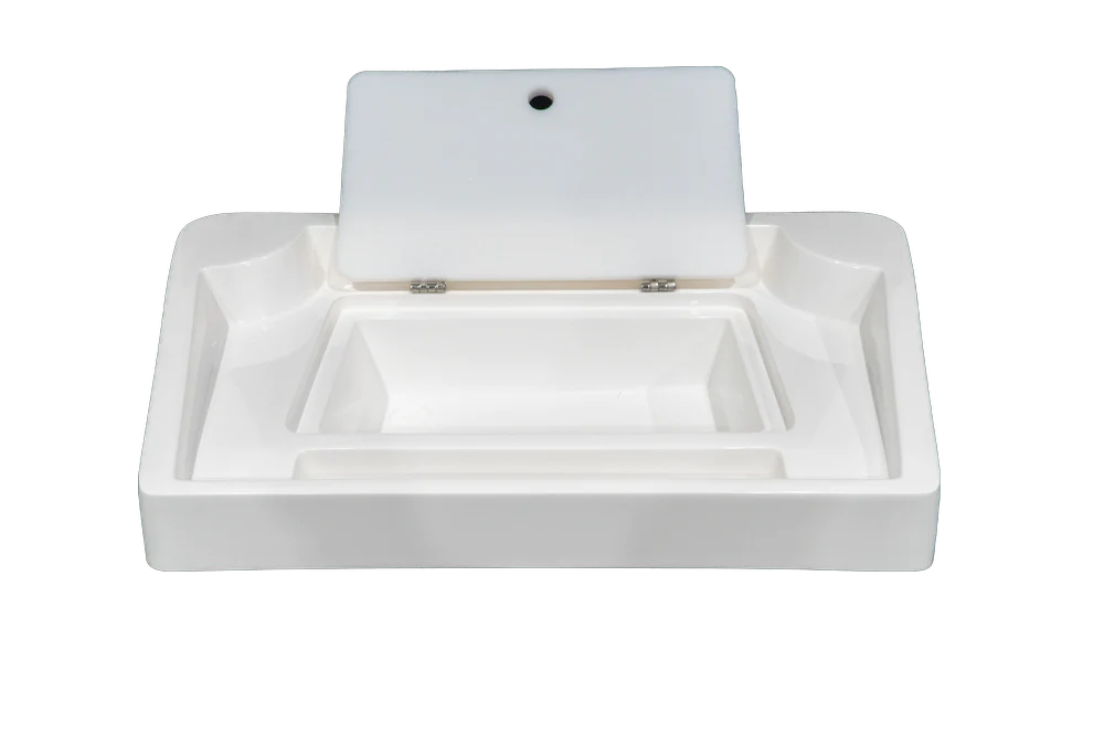 A white, rectangular fishing bait station with the lid open. The station has a large, rectangular compartment with several smaller compartments around it. There is a drain hole in the center of the compartment.